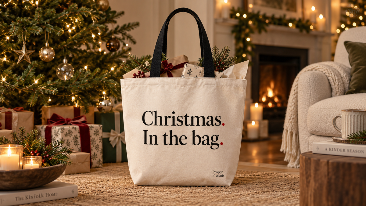 Proper Presents Christmas in the bag canvas tote in a festive living room